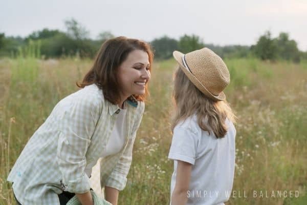A mother talking to a child using adjectives about kids to improve self confidence and self esteem.