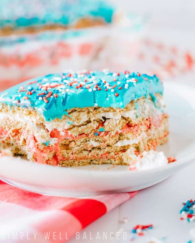 Close up of the red, white and blue patriotic icebox cake. Layers of cool whip, graham crackers and frosting. 