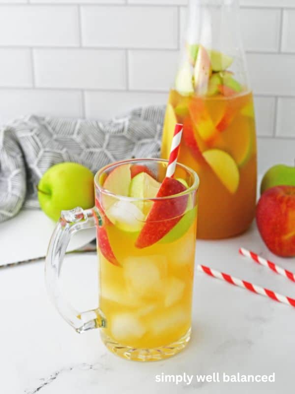 A pitcher of apple pie punch on a kitchen counter. 