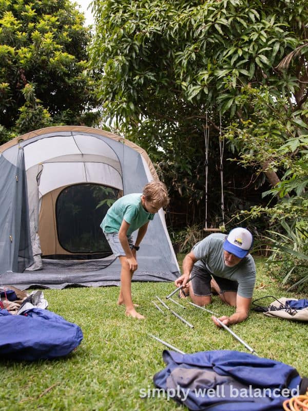 Father and son doing a backyard campout for a screen free summertime activity. 