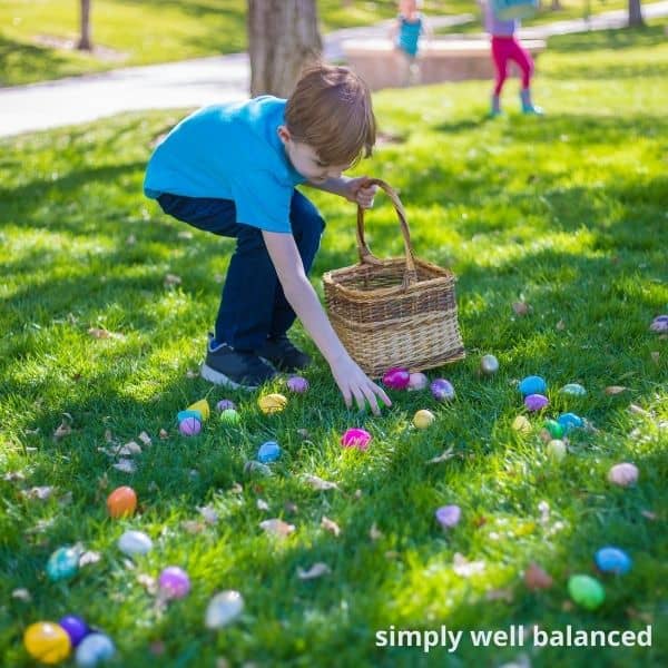 Boy finding Easter Eggs in yard. 