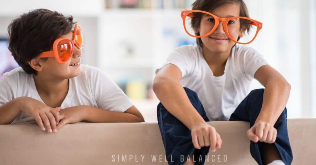 Brothers wearing silly glasses. 