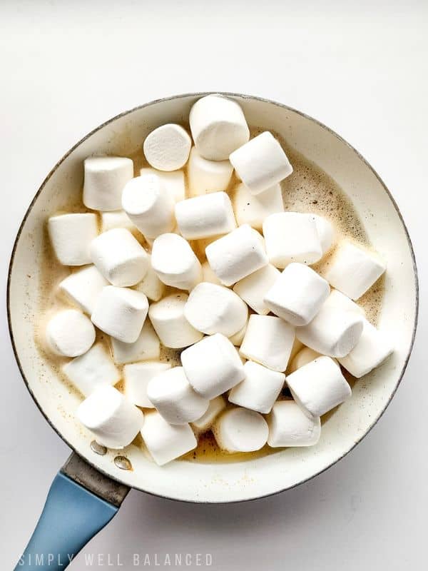 Marshmallows added to a pan of butter to make cookie monster rice crispy treats. 