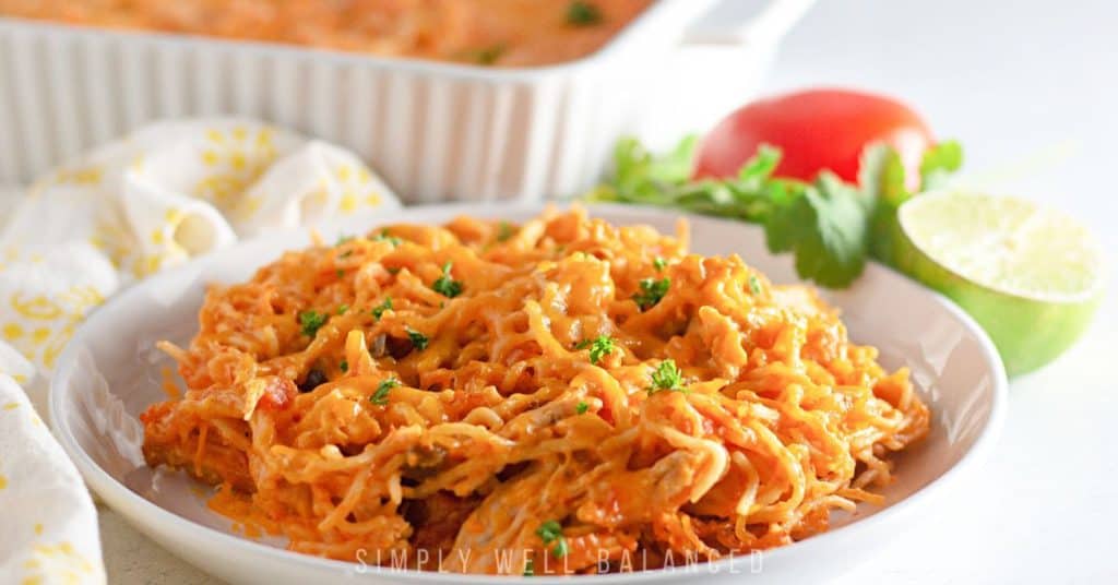 Close up of chicken taco spagetti bake with parsley garnish. 