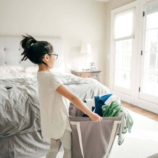 Child being responsible for their own laundry.