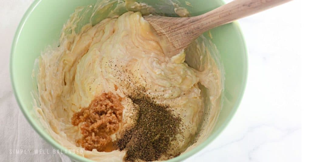 Mixing the ingredients for the chicken tetrazzini sauce in a bowl. 