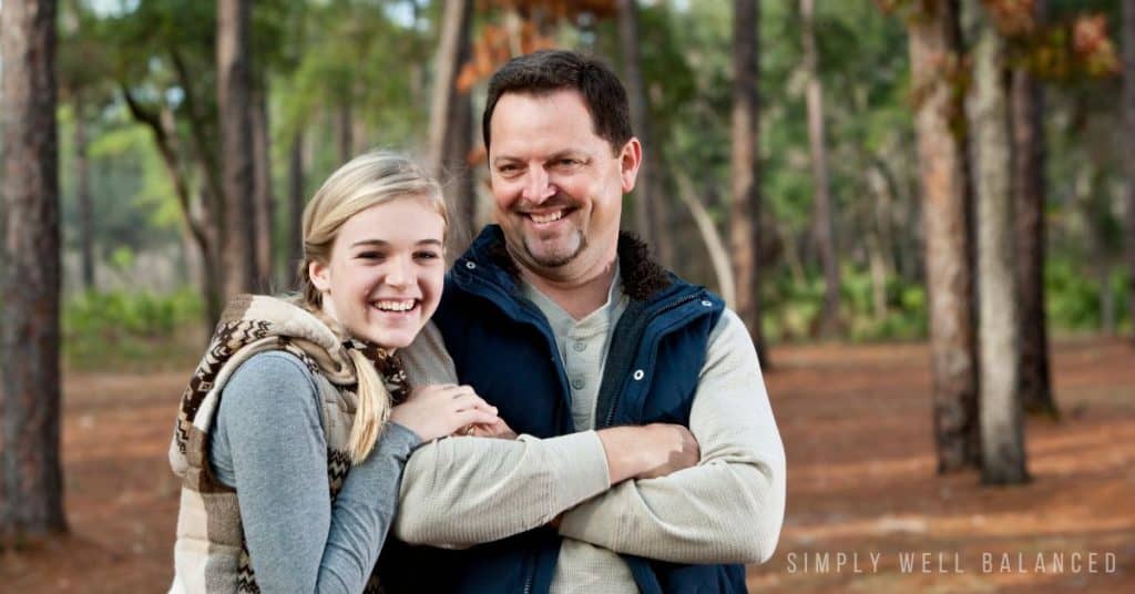 Dad and teen daughter on a hike.