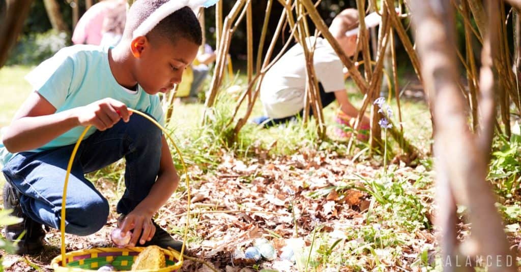 Kids looking for Easter Eggs hidden in a pile of leaves during and Easter Egg Hunt. 