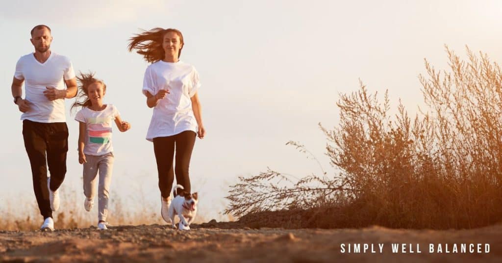 Family going for a jog together outside to teach their child the importance of health and fitness. 