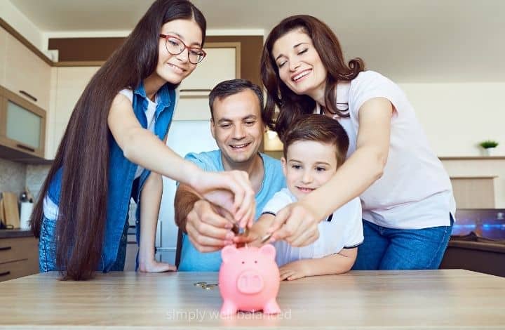 Family putting money in a piggy bank.