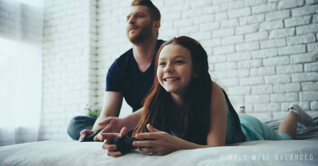 Daddy teenage daughter playing video games.
