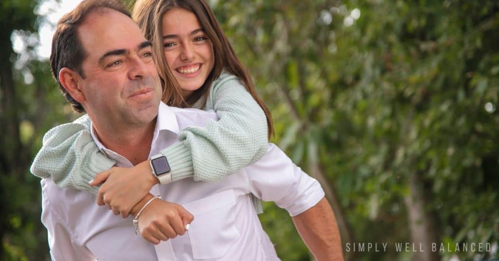 Dad and tween daughter hanging out together. 