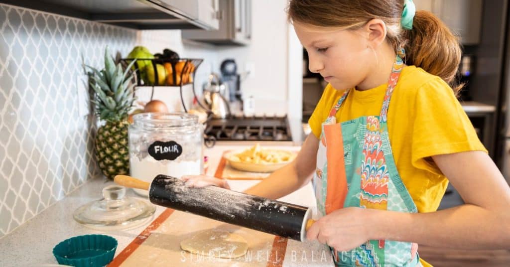 Young girl learning to make breakfast on her own during summer break. 