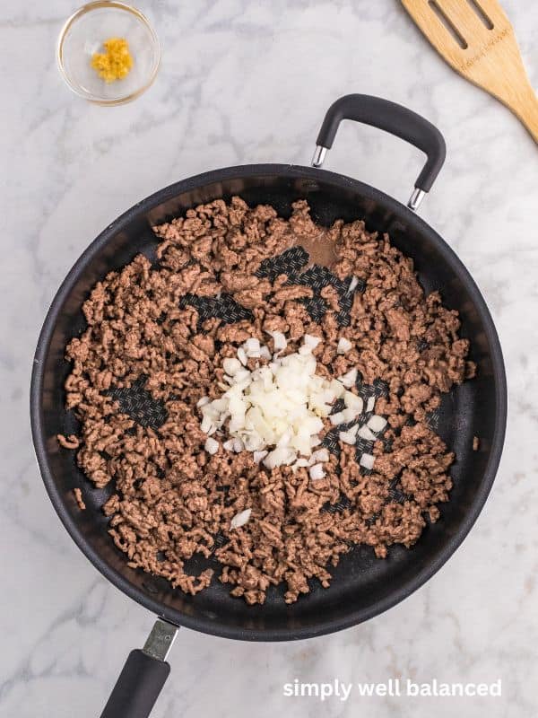 Ground beef and onions cooking in a pan. 
