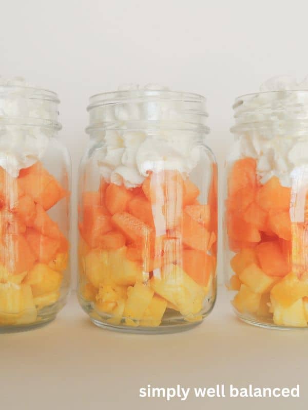 Halloween Candy Corn Parfait with pineapple, cantaloupe, and whipped cream.