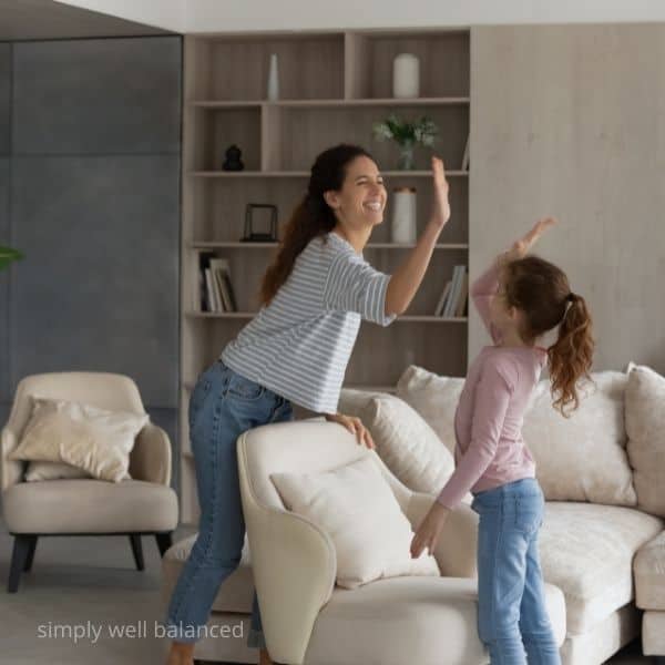 Mom giving daughter a high five for being responsible.