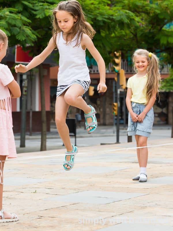 A group of young girls playing Chinese jump rope - no screen summer activity idea. 