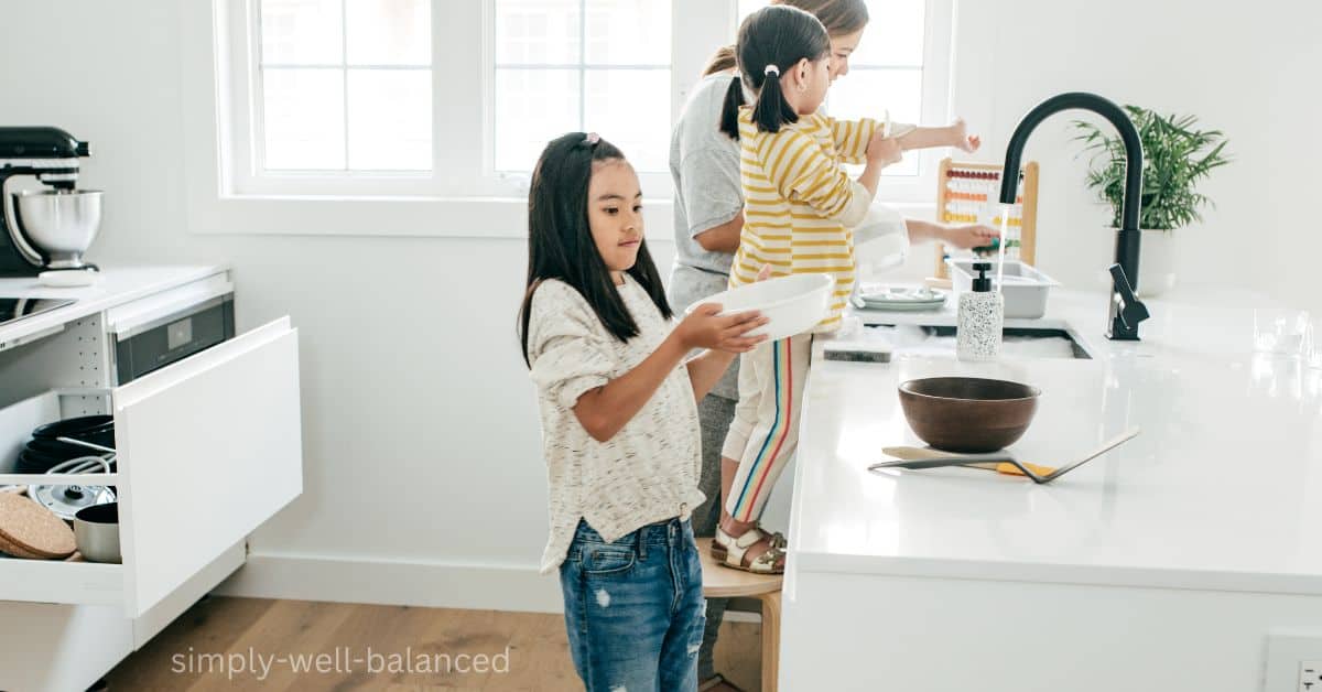 A mom helping her kids learn how to do chores in the kitchen.