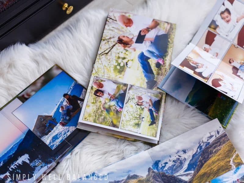 Family photo books arranged on a white fur rug. A photo book service is a great gift idea. 