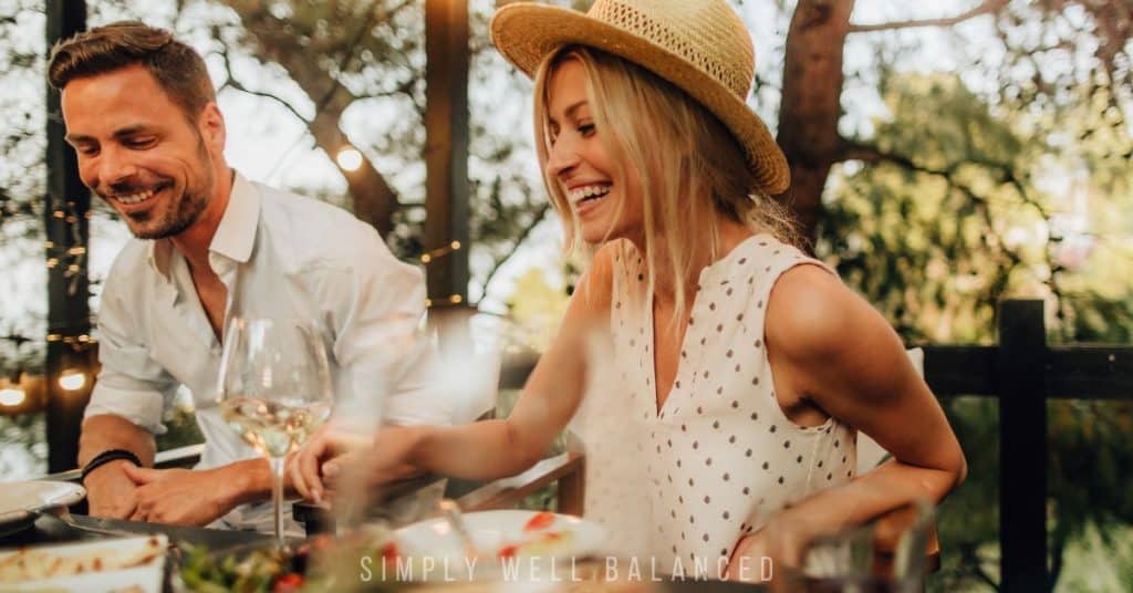 Couple sitting down to enjoy dinner - a summer casserole.