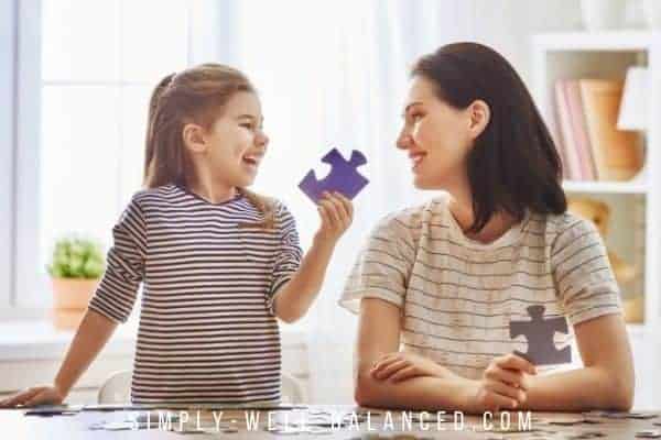 Mother and daughter putting together a puzzle.