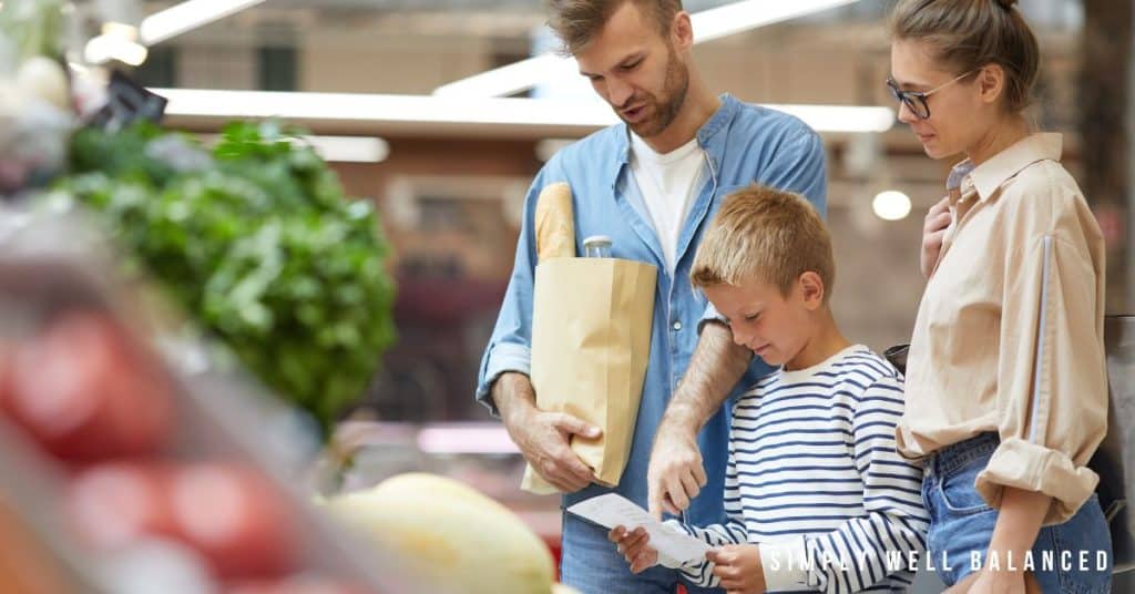 Parents teaching their son how to grocery shop and follow a shopping list.  An essential life skill to teach your children. 