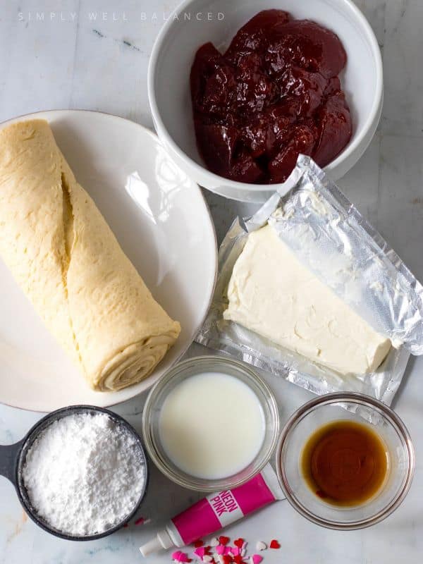 Ingredients for Valentine\'s Day Croissants: Crescent rolls, strawberry jam, cram cheese, milk, powdered sugar and vanilla. 