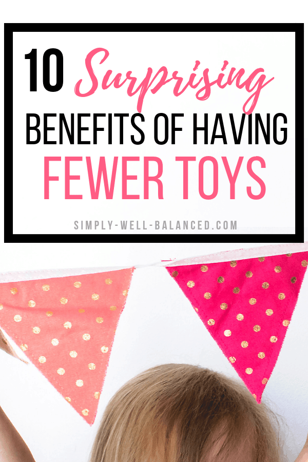 Image of pink and gold polka dot flags hanging on the wall. Pink and black text overlay reads "10 surprising benefits of having fewer toys"